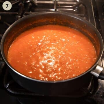 simmering ketchup in a large saucepan.