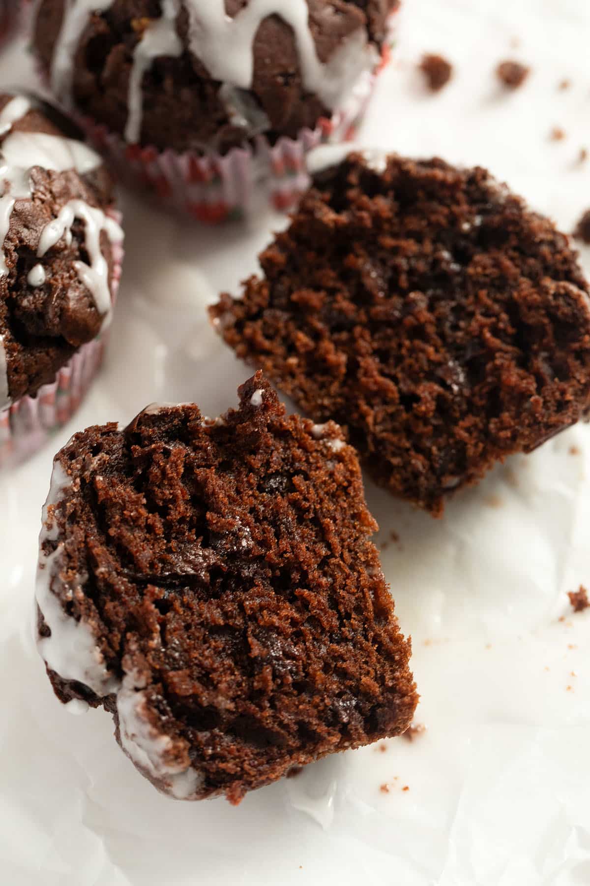 one halved pumpkin muffin with chocolate and cocoa showing the super moist crumb.