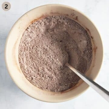 mixed dry ingredients for making muffins with pumpkin and cocoa in a bowl.