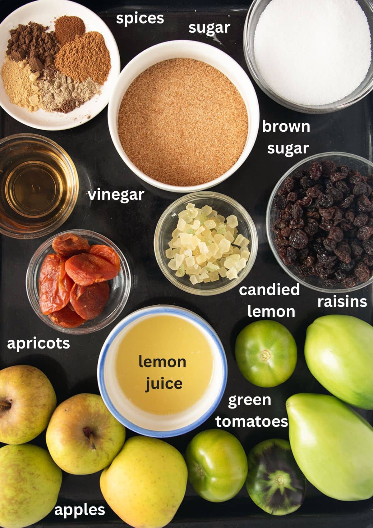 labeled ingredients for making mincemeat with green tomatoes, apples, spices, and dried fruit.