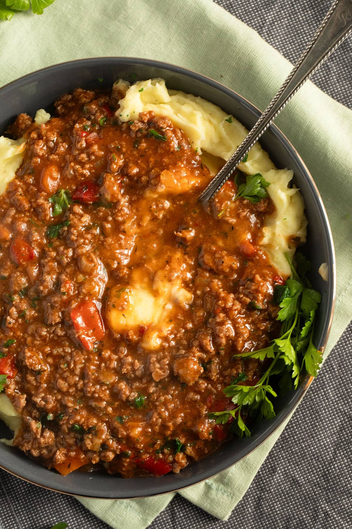 close-up of ground beef mashed potatoes in a rustic serving bowl.