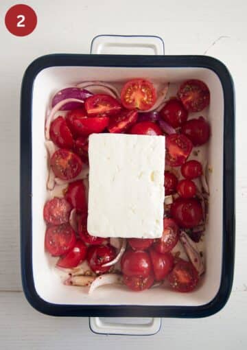 one block of feta and chopped tomatoes and onions in a baking dish.