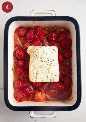 a block of baked feta on top of juicy cherry tomatoes.