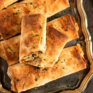golden and crispy chicken filo parcels sprinkled with parsley.