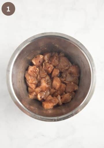 small choppped chicken breast mixed with soy sauce, and seasoning to make the filling for filo parcels.