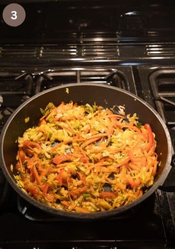 sauteing shredded cabbage, carrots and peppers in a large pan to make the filling for filo parcels.