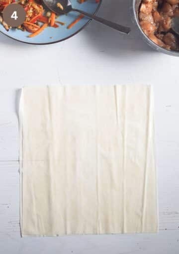 two stapled filo sheets brushed with oil for making parcels.