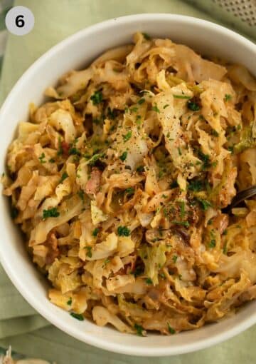 cooked savoy cabbage with bacon and cream in a large bowl.