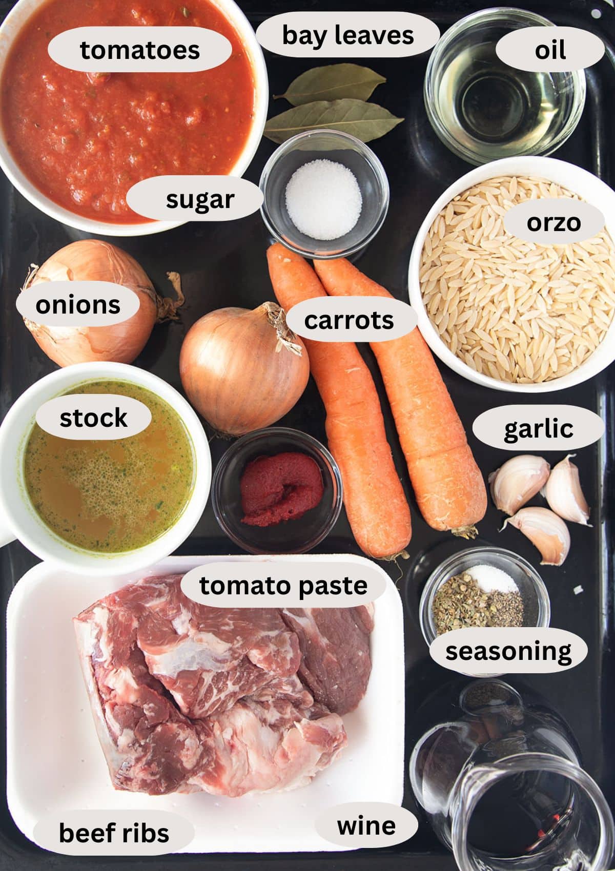 ingredients for making greek youvetsi with beef short ribs, tomato sauce and orzo.