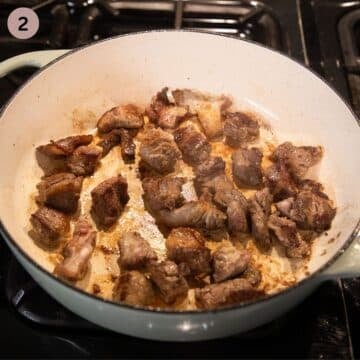 browning pieces of beef in a pot to make youvetsi.
