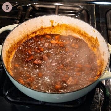 beef simmering in tomato sauce to make greek youvetsi.