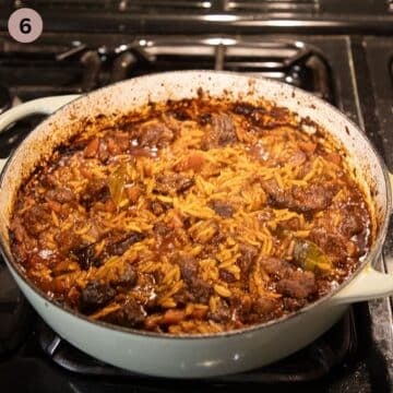 youvetsi recipe simmering in a large pot.