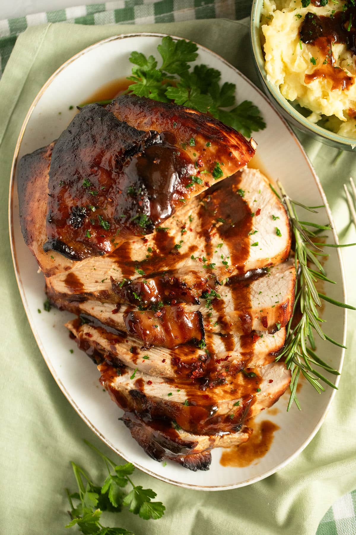 large turkey breast baked with honey, sliced and served with sauce and mashed potatoes. 