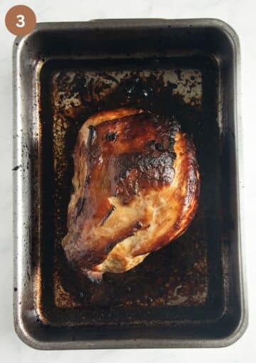 honey baked turkey in a roasting tin directly after removing it from the oven.