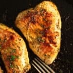 Juicy, fully cooked turkey steaks in a cast iron skillet, perfectly seared and ready to eat.
