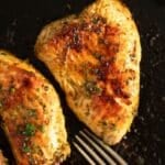 Pin image for juicy, perfectly cooked turkey steaks on a plate, garnished with fresh herbs.