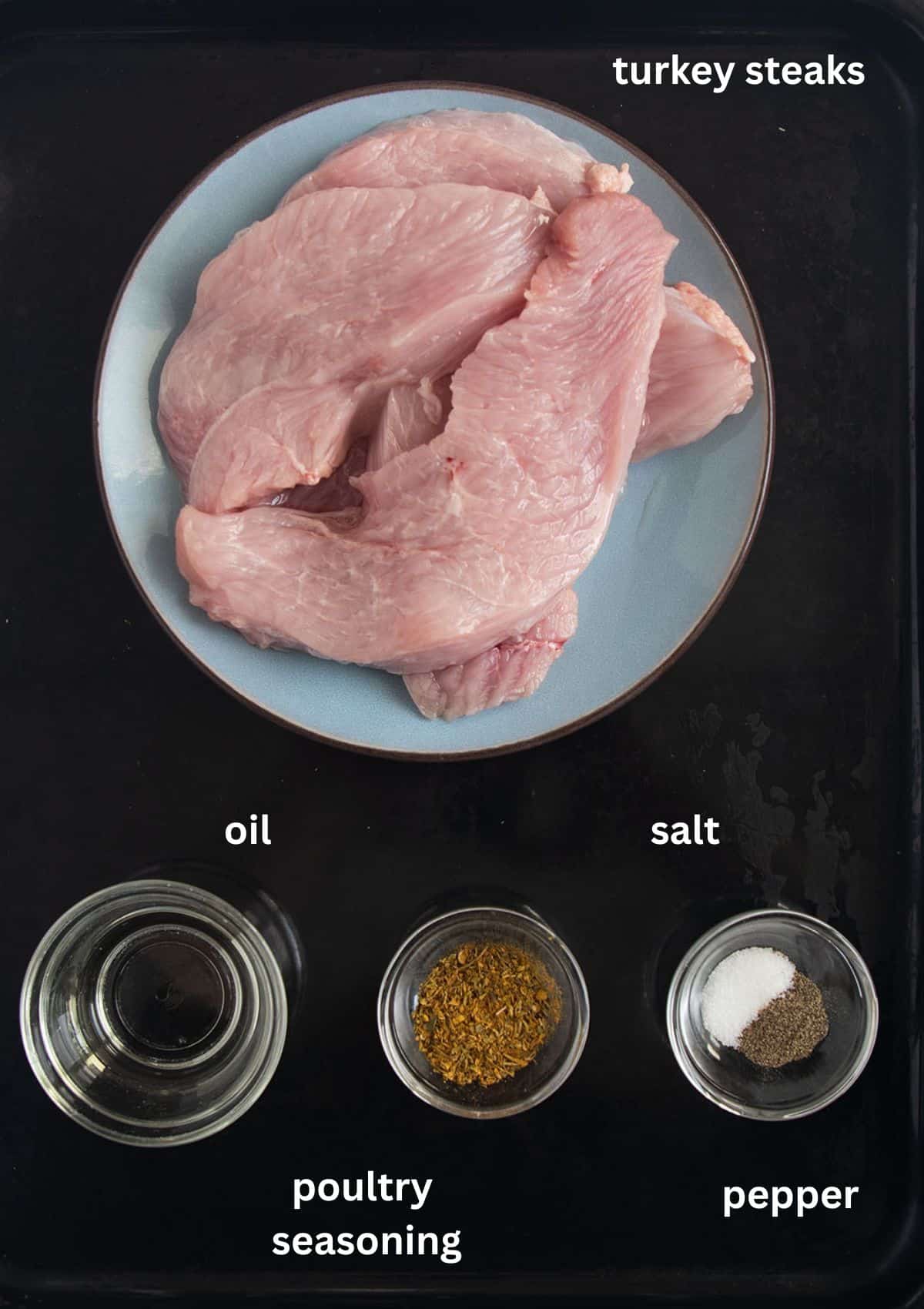 Ingredients for turkey steaks on a cutting board: raw turkey, oil, salt, pepper, and optional poultry seasoning.