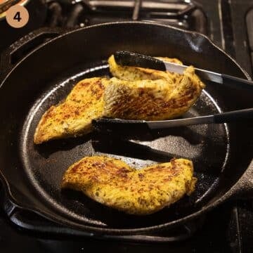 Cooking turkey steaks on medium heat, using tongs to sear the edges evenly.