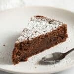 a slice of chocolate and ricotta cake with a spoon on a plate.