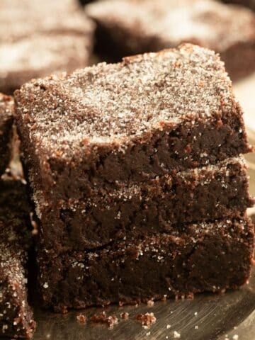three pieces of cocoa shortbread sprinkled with granulated sugar on a vintage plate.