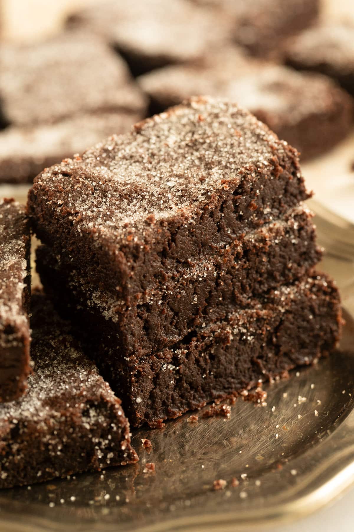 three pieces of shortbread with cocoa stapled on a vintage metal plate.
