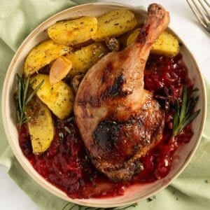 plum sauce for duck served on a plate with potatoes.