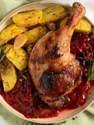 plum sauce for duck served on a plate with potatoes.