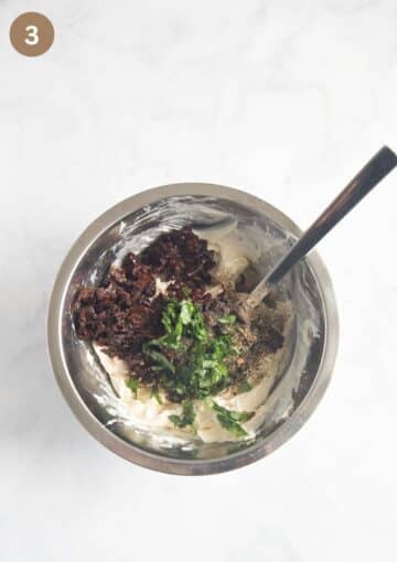 Chopped sun-dried tomatoes, garlic, basil, and spices combined with cream cheese to make a flavorful dip.