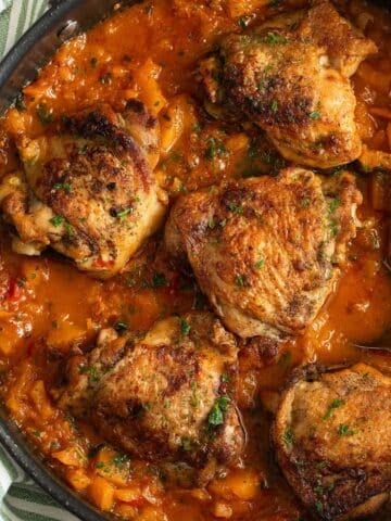 butternut sqsuash chicken with sauce in a pan.