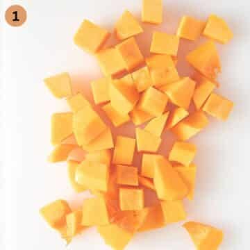 butternut squash cubes on a cutting board.