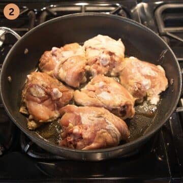 searing chicken thighs on the skin side in a large pan.