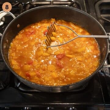roughly mashing butternut sauce for chicken with a potato masher.