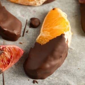 chocolate-dipped orange slices on parchment paper.