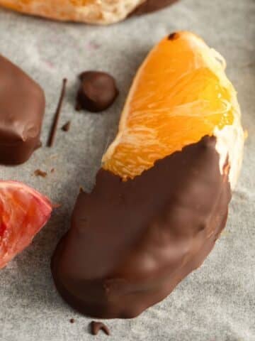 chocolate-dipped orange slices on parchment paper.