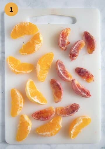 orange and blood orange slices on a cutting board.