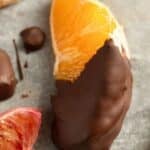 pinterest image with the title chocolate dipped oranges.