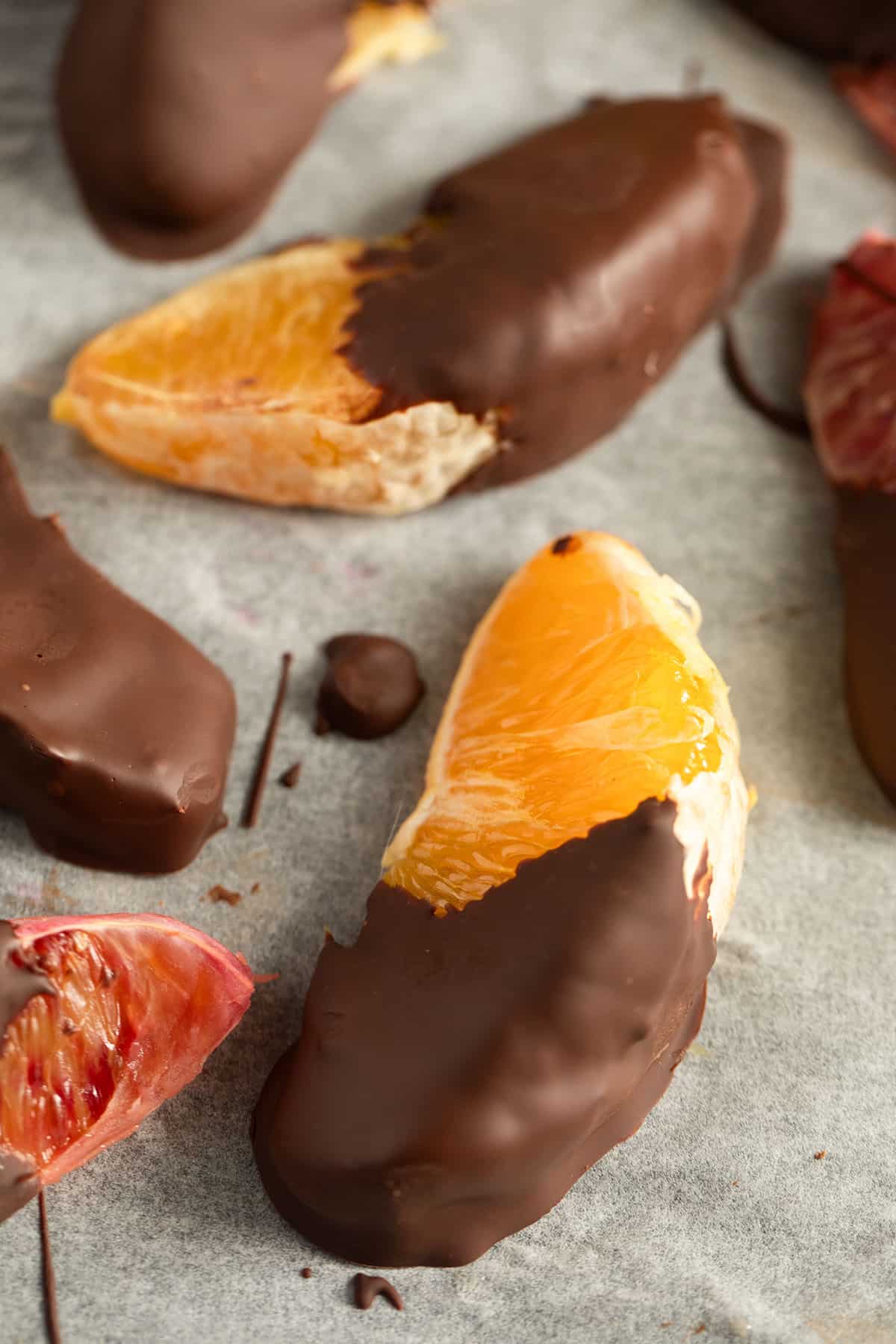 two large slices of orange coated with dark chocolate.