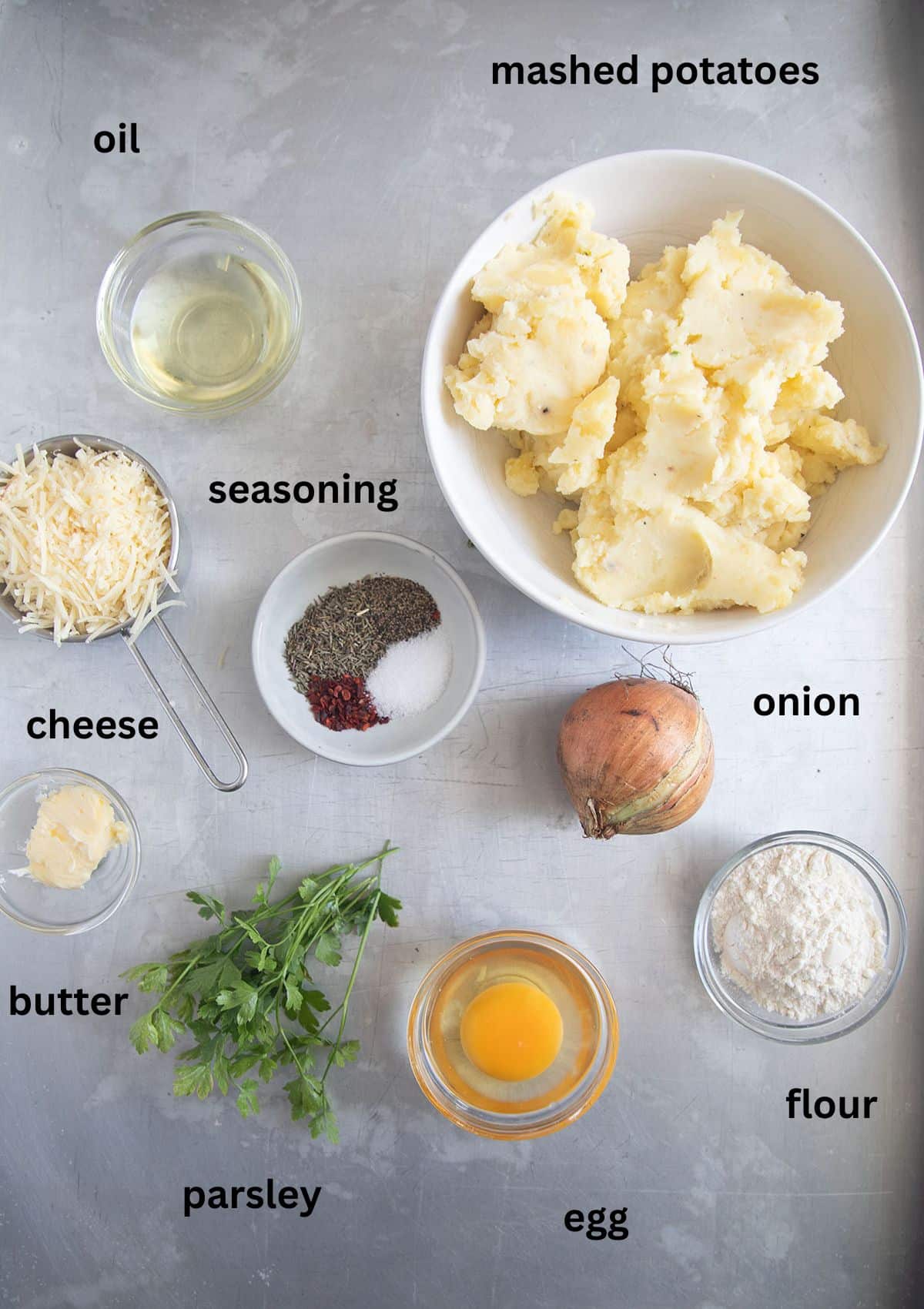 labeled ingredients for making patties with mashed potatoes, cheese, onion, parsley, flour and egg.
