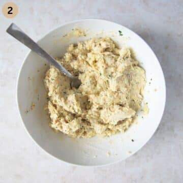 leftover mashed potato mixture in a bowl with a spoon in it.