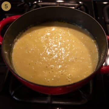 blended soup with pears and parsnips in a soup pot on the stovetop.