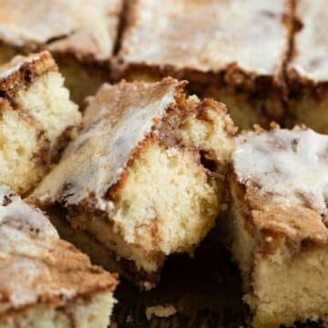 pieces of super fluffy cinnamon swirl cake with cream cheese glaze.