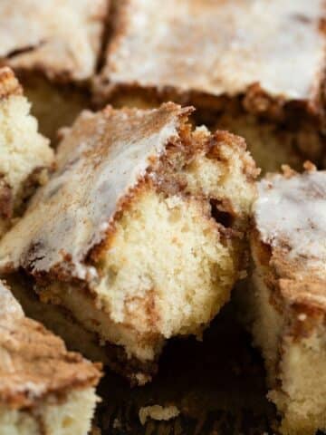 pieces of super fluffy cinnamon swirl cake with cream cheese glaze.