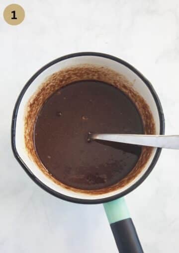 topping for cinnamon swirl for cake in a saucepan with a spoon in it.