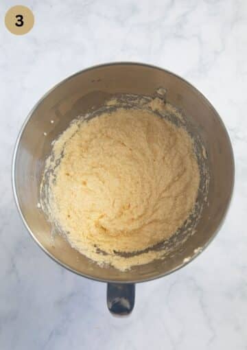 adding eggs to cake batter in a bowl.