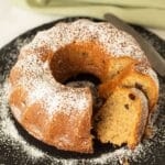 irish coffee cake sprinkled with confectioner's sugar and a few sliced pieces.