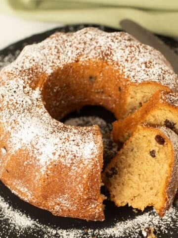 irish coffee cake sprinkled with confectioner's sugar and a few sliced pieces.