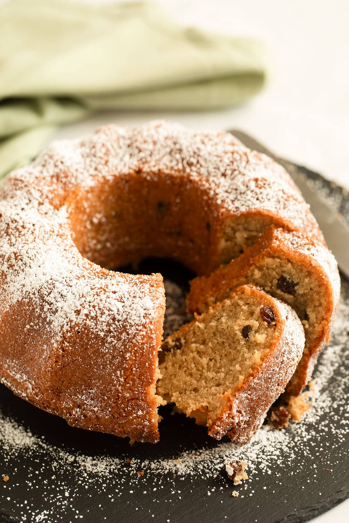 sliced irish coffee cake with raisins and whiskey on a cake platter.