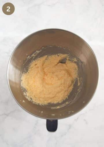 mixed butter, sugar and eggs to make cake batter in a bowl.