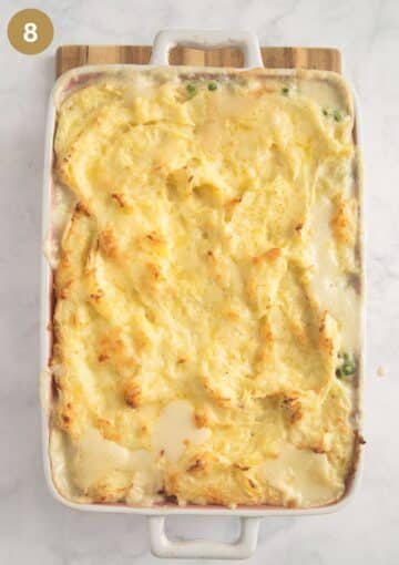 freshly baked fish pie with mashed potatoes and cheese in a baking dish.