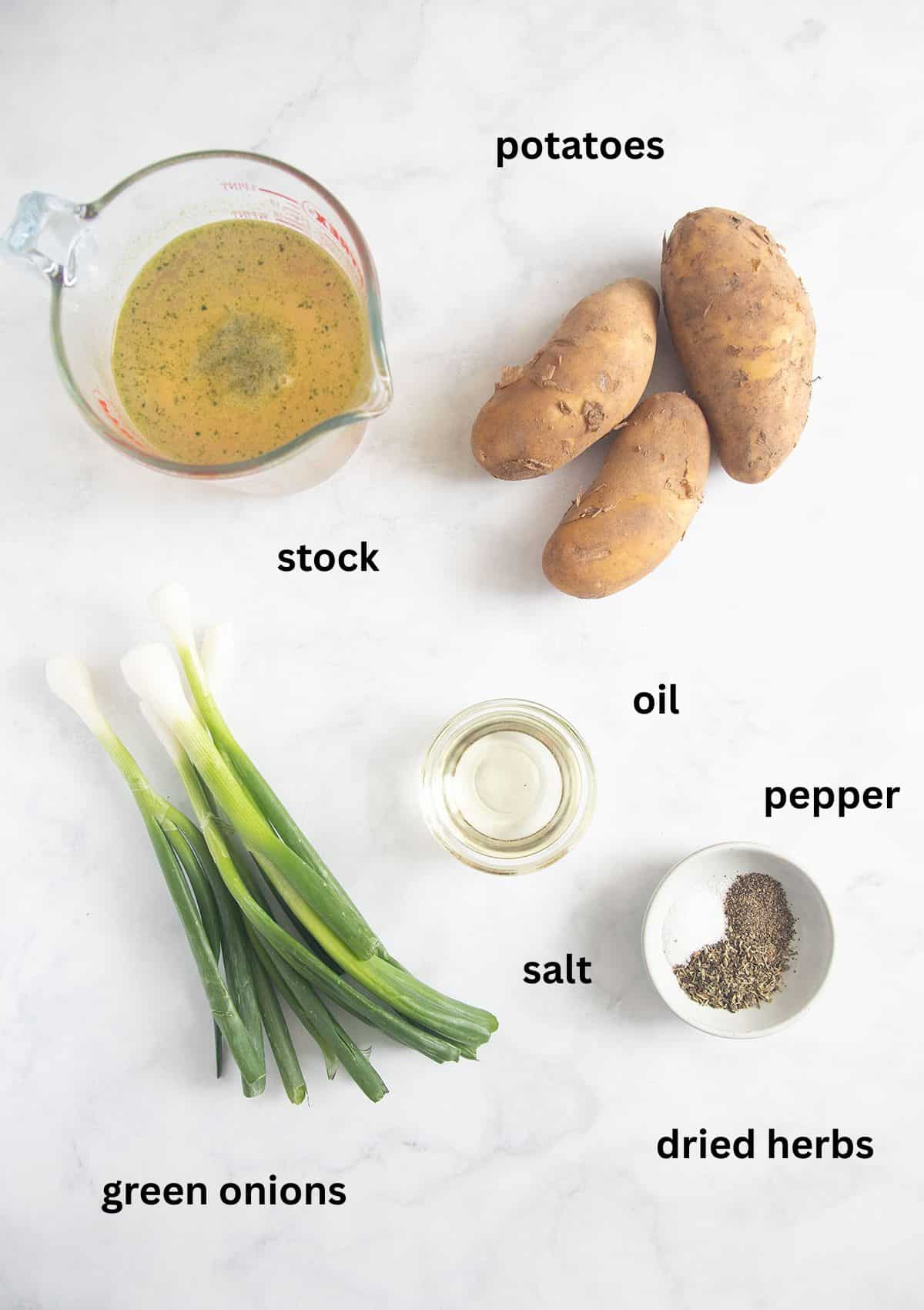 labeled ingredients for cooking potatoes with green onions, oil, salt, pepper, dried herbs and stock.